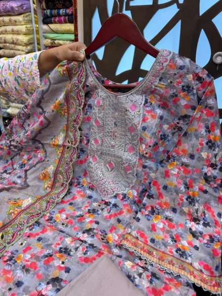 Elegant Pakistani-inspired Swiss Lawn suit with intricate boring work.